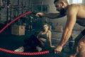 Men with battle rope battle ropes exercise in the fitness gym. Royalty Free Stock Photo