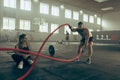 Men with battle rope battle ropes exercise in the fitness gym. Royalty Free Stock Photo