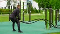 Men with battle rope battle ropes exercise in the street fitness gym. Royalty Free Stock Photo