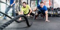 Men with battle rope in functional training fitness gym Royalty Free Stock Photo