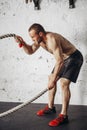 Men with battle rope battle ropes exercise in fitness gym Royalty Free Stock Photo