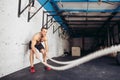 Men with battle rope battle ropes exercise in fitness gym Royalty Free Stock Photo