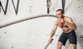 Men with battle rope battle ropes exercise in fitness gym Royalty Free Stock Photo