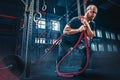 Men with battle rope battle ropes exercise in the fitness gym. CrossFit. Royalty Free Stock Photo