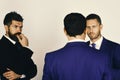 Men with beard and interested faces discuss business. Argument and business concept. CEOs settle disputes on light grey Royalty Free Stock Photo