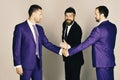 Men with beard and smiling faces discuss business or gage. Career and competition concept. Businessmen wear smart suits