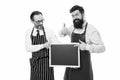 Men bearded bartender or cook in apron hold blank chalkboard. Workers wanted. Bartender with blackboard. Hipster Royalty Free Stock Photo