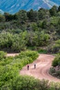 Men biclying on dirt mountain road pikes peak mountain range colorado springs