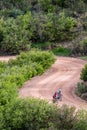 Men biclying on dirt mountain road pikes peak mountain range colorado springs