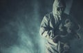 Men in Biohazard Mask and Hazmat Suit with Teddy Bear Royalty Free Stock Photo