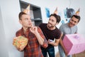 Men in birthday hats are preparing a surprise birthday party. They are preparing to meet the birthday girl. Royalty Free Stock Photo