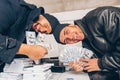 Men in black counting money in basement Royalty Free Stock Photo