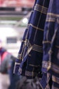 Men`s blue plaid shirts on hangers in the store Royalty Free Stock Photo