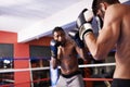 Men, boxing ring and gloves for fight competition in gym for challenge practice as opponents for workout, exercise or