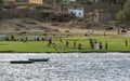 People playing football on the bank of the River Nile at Esna in Egypt. Royalty Free Stock Photo