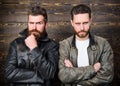 Men brutal bearded hipster posing in fashionable black leather jackets. Leather fashion menswear. Handsome stylish and Royalty Free Stock Photo