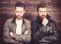Men brutal bearded hipster posing in fashionable black leather jackets. Leather fashion menswear. Handsome stylish and Royalty Free Stock Photo