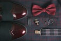 Men burgundy suit, bow tie and vintage leather shoes on textile tweed background Royalty Free Stock Photo