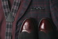 Men burgundy suit, bow tie and vintage leather shoes on textile tweed background Royalty Free Stock Photo