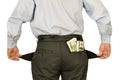 Men businessman showing empty pockets hiding behind wads of money