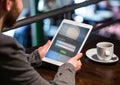 Men in a cafeteria with tablet in login screen Royalty Free Stock Photo