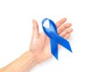 Men cancer. Blue ribbon in hands isolated on white background. Awareness prostate cancer of men health in Movember. Adrenocortical