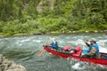 Men canoeing on turbulent river in wild Alaska Royalty Free Stock Photo