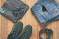 Men casual outfits. Men shoes, clothing and accessories on wooden background - grey t-shirt, blue jeans, sneakers with eyeglass Royalty Free Stock Photo