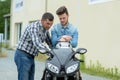 men checking motorcycle in suite