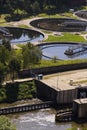 Men checking water tanks at sewage treatment plant