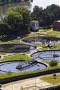 Men checking water tanks at sewage treatment plant