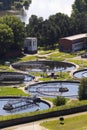 Men checking water tanks at sewage treatment plant