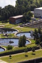 Men checking water tanks at sewage treatment plant