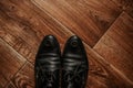 Men classic fashion formal black shoes. boots on a brown textured wooden floor. Royalty Free Stock Photo