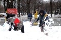 Men clean the city after extreme snowfall in Moscow.