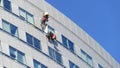 Men clean the windows of a building Royalty Free Stock Photo