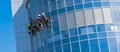 Men cleaning glass building. high-rise, industrial alpinism. Royalty Free Stock Photo