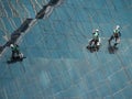 Men cleaning glass building