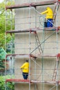 Men cleaning wall. Scaffolding Royalty Free Stock Photo
