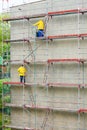 Men cleaning wall. Scaffolding Royalty Free Stock Photo