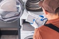 Men Cleaning Washer and Dryer Filter Royalty Free Stock Photo