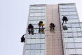 Men cleaning windows on a corporate bouilding Royalty Free Stock Photo