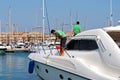 Men cleaning a yacht, Sotogrande. Royalty Free Stock Photo