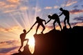 Men climbers help each other in the mountains Royalty Free Stock Photo
