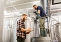 Men with clipboard at craft brewery or beer plant Royalty Free Stock Photo