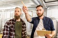 Men with clipboard at craft brewery or beer plant Royalty Free Stock Photo