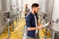 Men with clipboard at craft brewery or beer plant Royalty Free Stock Photo