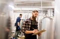 Men with clipboard at craft brewery or beer plant Royalty Free Stock Photo