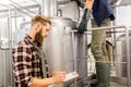 Men with clipboard at craft brewery or beer plant Royalty Free Stock Photo