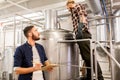 Men with clipboard at craft brewery or beer plant Royalty Free Stock Photo
